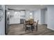 Modern kitchen with white cabinetry, stainless steel appliances, and a wooden dining table with chairs at 222 Rosewood Dr, Sanford, NC 27330