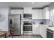 Modern kitchen with stainless steel appliances, white cabinets, and light wood flooring at 222 Rosewood Dr, Sanford, NC 27330