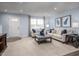 This spacious living room features neutral walls, plush carpeting, and comfortable seating near the front door at 222 Rosewood Dr, Sanford, NC 27330