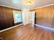 Bedroom featuring wood paneling, wood floors, and natural light at 2309 Chautauqua Ave, Durham, NC 27707
