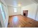 Inviting living room showcasing a brick fireplace, wood floors and natural light at 2309 Chautauqua Ave, Durham, NC 27707