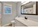 Well-lit bathroom featuring a white vanity, neutral wall color, and a large mirror at 2312 Brasswynd Ct, Fuquay Varina, NC 27526