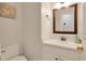 Bright bathroom featuring a single sink vanity, decorative wall art, and neutral wall paint at 2312 Brasswynd Ct, Fuquay Varina, NC 27526