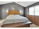 Bedroom features a large bed, bench, wood furniture, decorative wall art, and a ceiling fan at 2312 Brasswynd Ct, Fuquay Varina, NC 27526