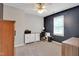 Bedroom featuring a ceiling fan, accent wall, and desk with built in shelving at 2312 Brasswynd Ct, Fuquay Varina, NC 27526