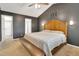 Primary bedroom boasts a bed, bench, vaulted ceilings, and a decorative wall art piece at 2312 Brasswynd Ct, Fuquay Varina, NC 27526