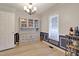 Dining room with light-colored walls, classic chandelier, and built in cabinet at 2312 Brasswynd Ct, Fuquay Varina, NC 27526