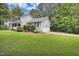 Home exterior showcasing attached garage, manicured lawn, and verdant landscaping at 2312 Brasswynd Ct, Fuquay Varina, NC 27526