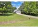View of the house from a distance showing the lawn, garage, and part of the driveway at 2312 Brasswynd Ct, Fuquay Varina, NC 27526