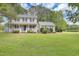 Charming two-story home with a welcoming front porch and lush green lawn at 2312 Brasswynd Ct, Fuquay Varina, NC 27526