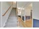 Entryway showcasing staircase and hardwood flooring with blue and white wainscoting at 2312 Brasswynd Ct, Fuquay Varina, NC 27526