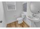 Well-lit half bath featuring pedestal sink and artwork at 2371 Old Us 421, Lillington, NC 27546