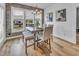 Cozy dining area featuring a brick accent wall, modern lighting, and a view to the backyard through large windows at 2371 Old Us 421, Lillington, NC 27546