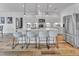 Bright kitchen with white cabinetry, a large island with seating, and modern pendant lighting, creating a stylish space at 2371 Old Us 421, Lillington, NC 27546
