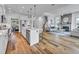 Open floor plan showcasing living room fireplace, kitchen island and barstool seating, and dining space at 2371 Old Us 421, Lillington, NC 27546