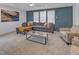 Spacious living room with a comfortable gray sectional, stylish decor, and plenty of natural light at 2371 Old Us 421, Lillington, NC 27546