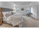 Comfortable main bedroom with tray ceiling, plush carpet, and chair near window at 2371 Old Us 421, Lillington, NC 27546