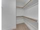 Empty walk-in closet with wooden rods for hanging and soft carpet at 2371 Old Us 421, Lillington, NC 27546