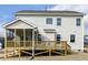 View of the back of the home showing a screened-in porch and an elevated deck with stairs to the backyard at 25 Long Needle Ct # 37, Youngsville, NC 27596