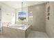 This bathroom features a soaking tub with a view and a tiled shower with glass enclosure at 25 Long Needle Ct # 37, Youngsville, NC 27596