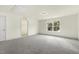 A carpeted bedroom boasts a walk-in closet and large window overlooking a leafy lot at 25 Long Needle Ct # 37, Youngsville, NC 27596