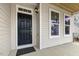 Inviting front door with sidelight and exterior light fixture at 25 Long Needle Ct # 37, Youngsville, NC 27596