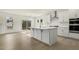 Modern kitchen with an island, sleek appliances, and hardwood flooring adjacent to dining area at 25 Long Needle Ct # 37, Youngsville, NC 27596