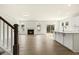 Open-concept living room with fireplace, hardwood floors, and seamless connection to the kitchen at 25 Long Needle Ct # 37, Youngsville, NC 27596