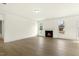 Bright living room boasts a fireplace, wood floors, and large windows at 25 Long Needle Ct # 37, Youngsville, NC 27596