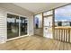 Screened-in porch area featuring wood flooring, railings, and sliding glass door at 25 Long Needle Ct # 37, Youngsville, NC 27596