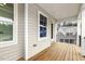 This covered porch has a wood floor and view of neighboring home at 25 Long Needle Ct # 37, Youngsville, NC 27596