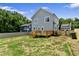 Backyard view of home featuring wooden deck, light-blue siding, white trim, and fenced yard at 2521 Newbold St, Raleigh, NC 27603