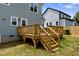 New wooden deck with stairs overlooking the backyard with partial view of neighbors house at 2521 Newbold St, Raleigh, NC 27603