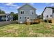 Backyard view of home featuring a wooden deck, light-blue siding, white trim, and a fenced yard at 2521 Newbold St, Raleigh, NC 27603