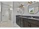 Modern bathroom showcasing a glass shower door, dual sink vanity, and contemporary tile flooring with gray walls at 2521 Newbold St, Raleigh, NC 27603