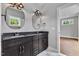 Stylish bathroom featuring a double sink vanity, granite countertop, and modern fixtures with decorative lighting at 2521 Newbold St, Raleigh, NC 27603