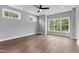 A bedroom with hardwood floors, white trim, gray walls and a ceiling fan at 2521 Newbold St, Raleigh, NC 27603