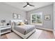 Cozy bedroom with a large window, a ceiling fan, and warm hardwood floors at 2521 Newbold St, Raleigh, NC 27603