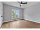 Bedroom featuring hardwood floors, a ceiling fan, and a bright window offering outdoor views at 2521 Newbold St, Raleigh, NC 27603