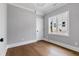 A bedroom features hardwood floors, gray walls, white trim, and a window at 2521 Newbold St, Raleigh, NC 27603