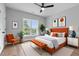 This bedroom features a modern design with an orange headboard and a large window at 2521 Newbold St, Raleigh, NC 27603