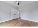 Spacious bedroom with hardwood flooring, ceiling fan and direct access to other rooms via large doors at 2521 Newbold St, Raleigh, NC 27603