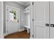 Entryway features a white door, coat rack with bench and coat storage at 2521 Newbold St, Raleigh, NC 27603