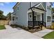 Side view of a charming home featuring a welcoming front porch and well-maintained landscaping at 2521 Newbold St, Raleigh, NC 27603