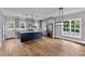 A spacious kitchen with gray cabinets, a blue island, stainless steel appliances and hardwood floors at 2521 Newbold St, Raleigh, NC 27603
