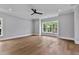 Bright and airy living room with hardwood floors, offering ample space and modern ceiling fan at 2521 Newbold St, Raleigh, NC 27603