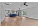Open-concept kitchen and living area with hardwood floors, showcasing modern design and ample natural light at 2521 Newbold St, Raleigh, NC 27603
