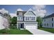 Charming two-story home with a two-car garage, manicured lawn, and classic architectural details at 259 Meadowbark Bnd # 32, Garner, NC 27529