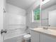 Bright bathroom featuring a shower-tub combo, vanity with sink, and natural light at 2705 Ramblegate Ln, Durham, NC 27705