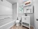Clean bathroom with a white vanity, a framed mirror, and a combined tub and shower at 2705 Ramblegate Ln, Durham, NC 27705